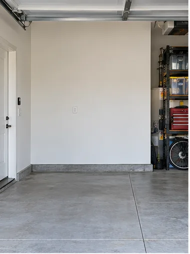 Stage 1: an empty garage wall with one duplex outlet.