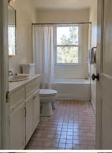 Before: a bathroom with the wall opened to the studs beside the tub, old pipes exposed.
